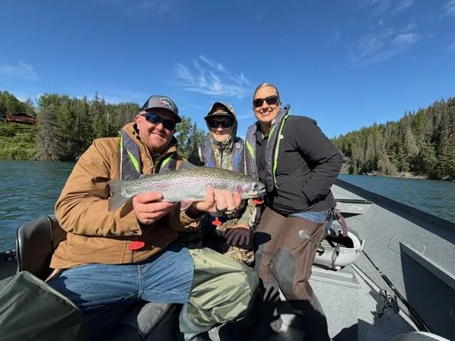 Guided angler with a large rainbow trout in the drift boat on the Kenai River, Cooper Landing, Alaska
